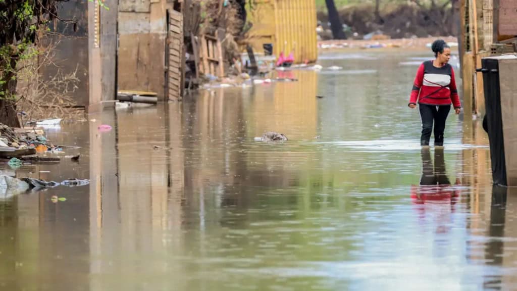 Mulher com água até o joelhos em enchente no Rio Grande do Sul