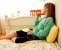 Adolescente escuta música em um discman