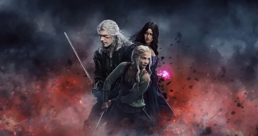 Imagem promocional de The Witcher mostra Geralt empunhando uma espada, Ciri em posição de combate e Yennefer segurando um feitiço roxo brilhante, cercados por fumaça e faíscas vermelhas