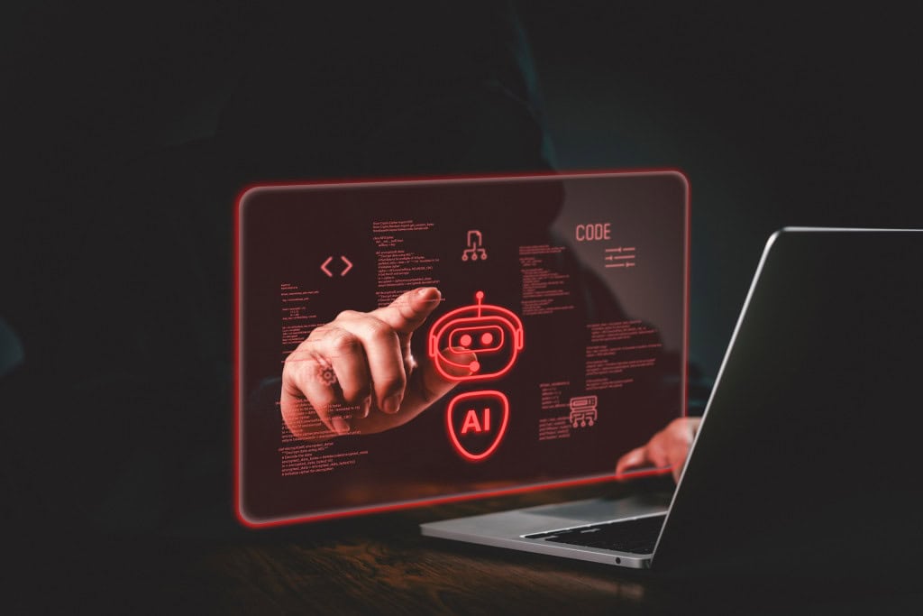 Robôzinho pairando ao lado da tela de um notebook