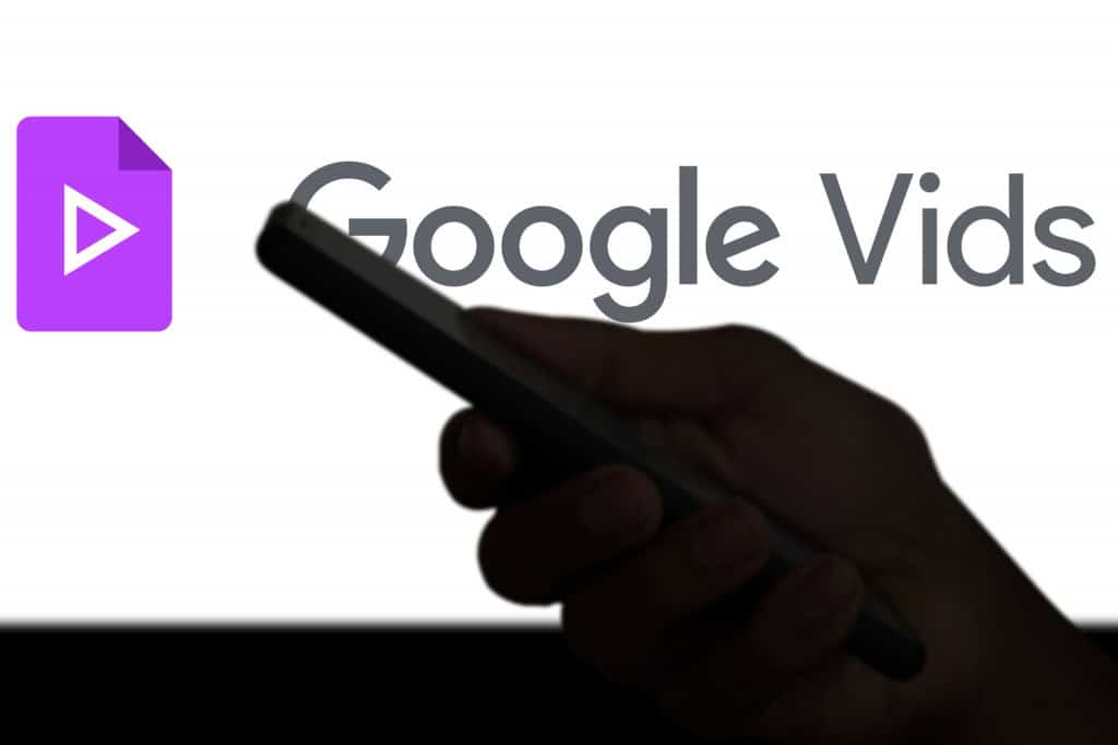 Ao fundo, logo do Google Vids; à frente, sombra de uma mão segurando um smartphone