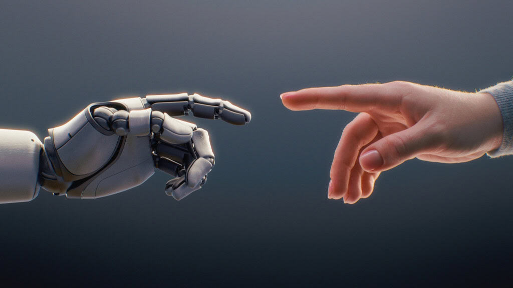 Mão humana e mão robótica se aproximam em imagem que representa a relação entre humanos e inteligência artificial.