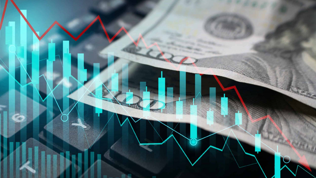 Dolár sobre teclado com índice mostrando negativa da economia