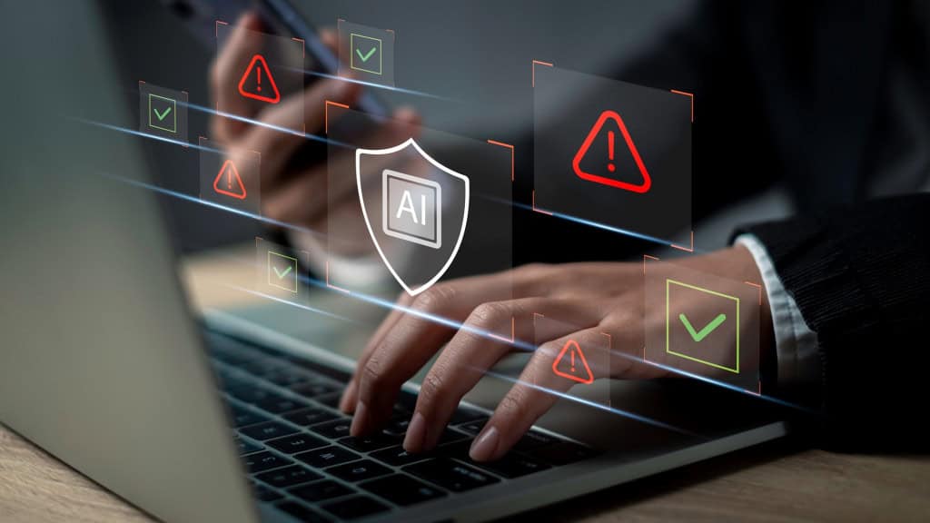 Ilustração mostra uma pessoa usando um notebook enquanto ícones de alerta e verificação representam mecanismos de segurança de uma inteligência artificial.